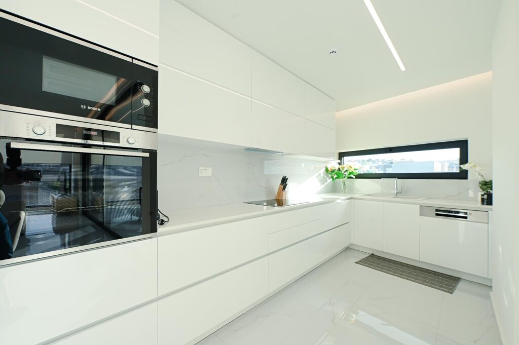 Fully equipped white kitchen with oven and hob in the Executive Deluxe Suite, Heraklion
