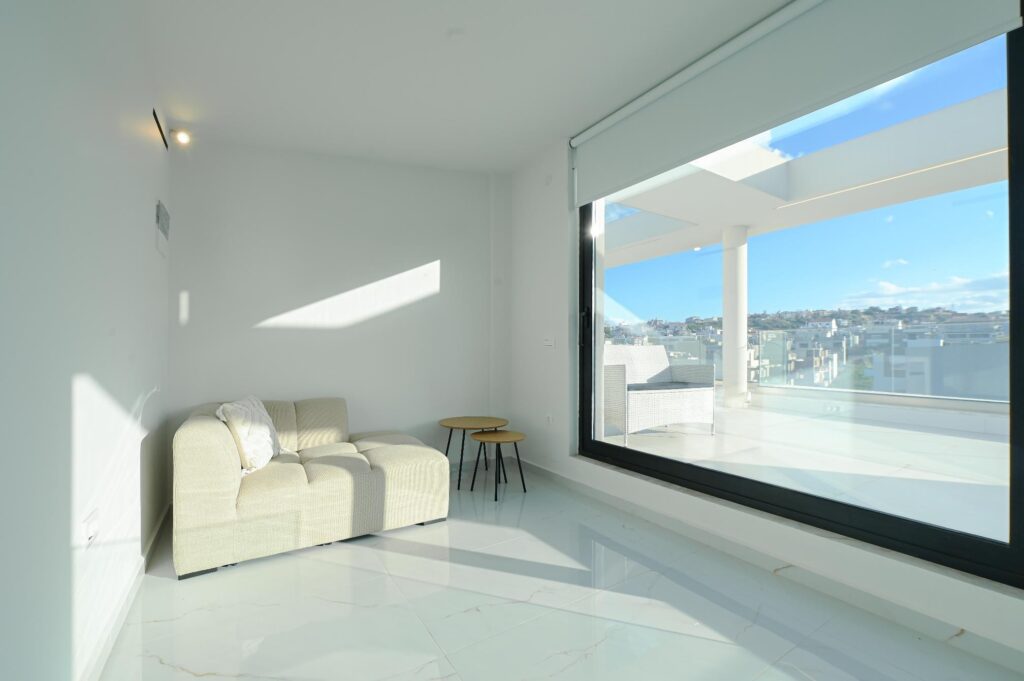 Bright living room with sofa and large window facing the terrace, Executive Deluxe Suite