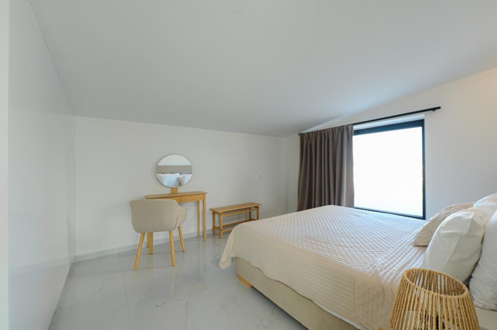 Double bedroom with desk and window in the Executive Deluxe Suite, KM Living Heraklion