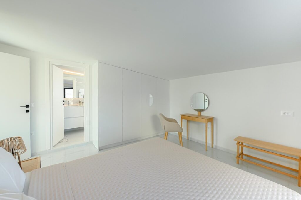 Bedroom with en-suite bathroom access and vanity desk in the Executive Deluxe Suite