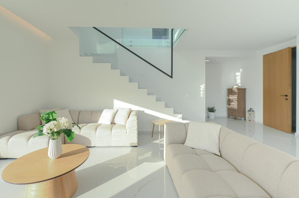 Corner sofa and staircase in the open-plan living room of the Executive Deluxe Suite