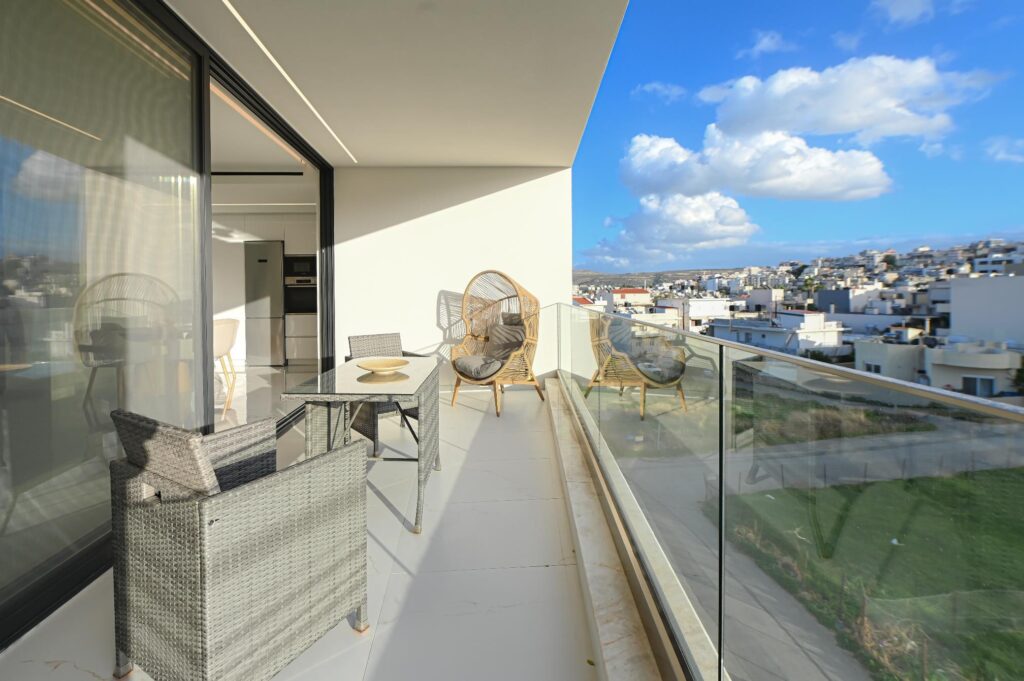 Furnished terrace with table and armchairs overlooking Heraklion city, Executive Deluxe Suite